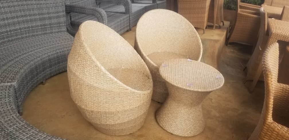 1 round wicker rattan table and 2 chairs of a natural colour